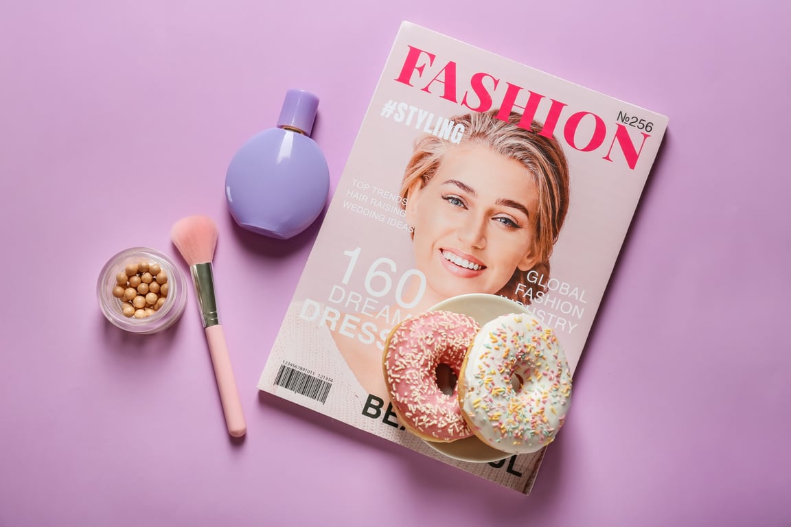 Glazed Donuts on Fashionable Magazine with Cosmetics